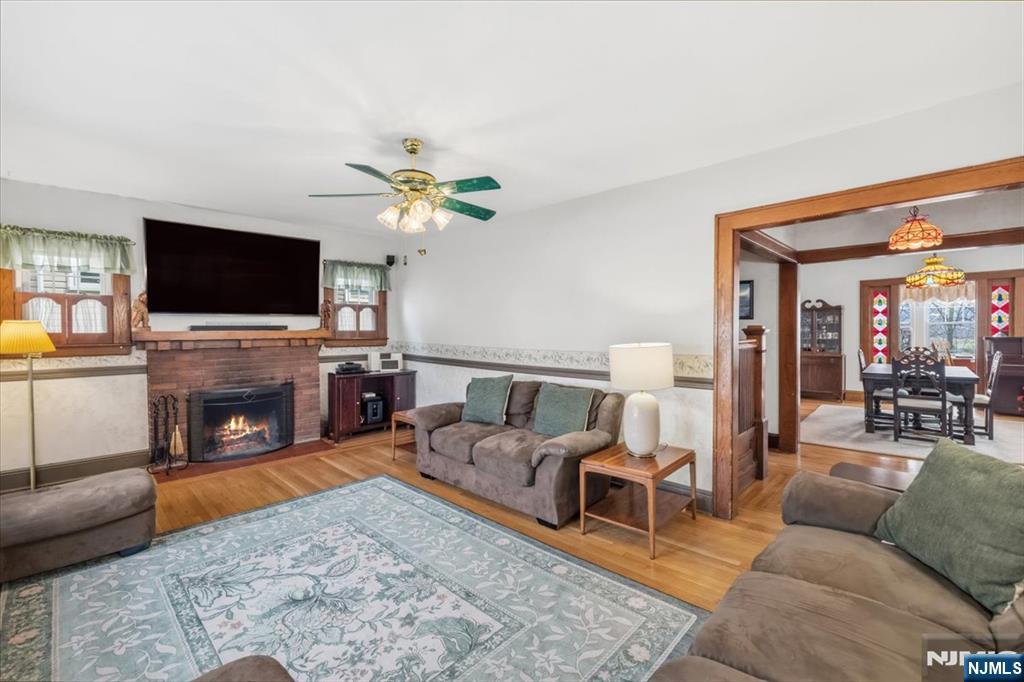 119 Overpeck Avenue Ridgefield Park, NJ 07660 - Photo 5 of 44 a living room with furniture a fireplace and a flat screen tv