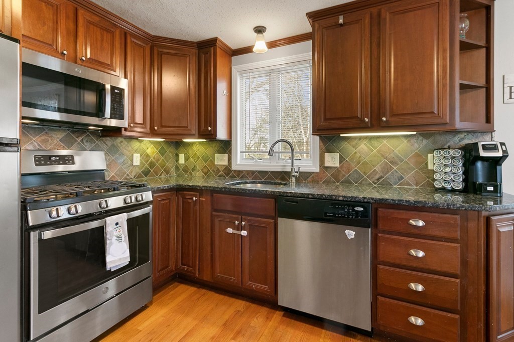190 West Allen Ridge Road Springfield, MA 01118 - Photo 11 of 39 a kitchen with stainless steel appliances granite countertop a stove a sink and a microwave