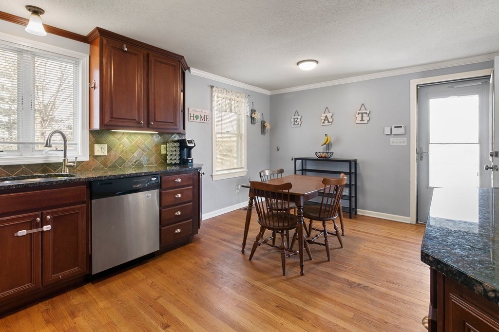 190 West Allen Ridge Road Springfield, MA 01118 - Photo 7 of 39 a kitchen with granite countertop wooden cabinets dining table and chairs