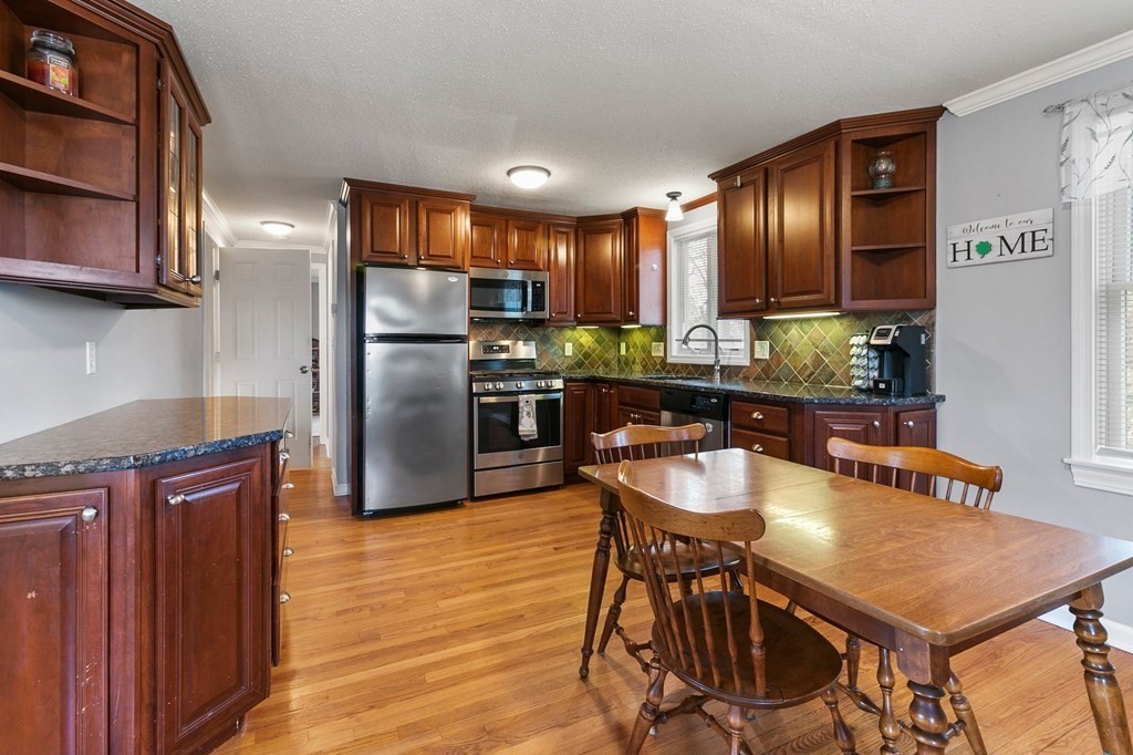 190 West Allen Ridge Road Springfield, MA 01118 - Photo 8 of 39 a kitchen with stainless steel appliances granite countertop a table chairs and a refrigerator