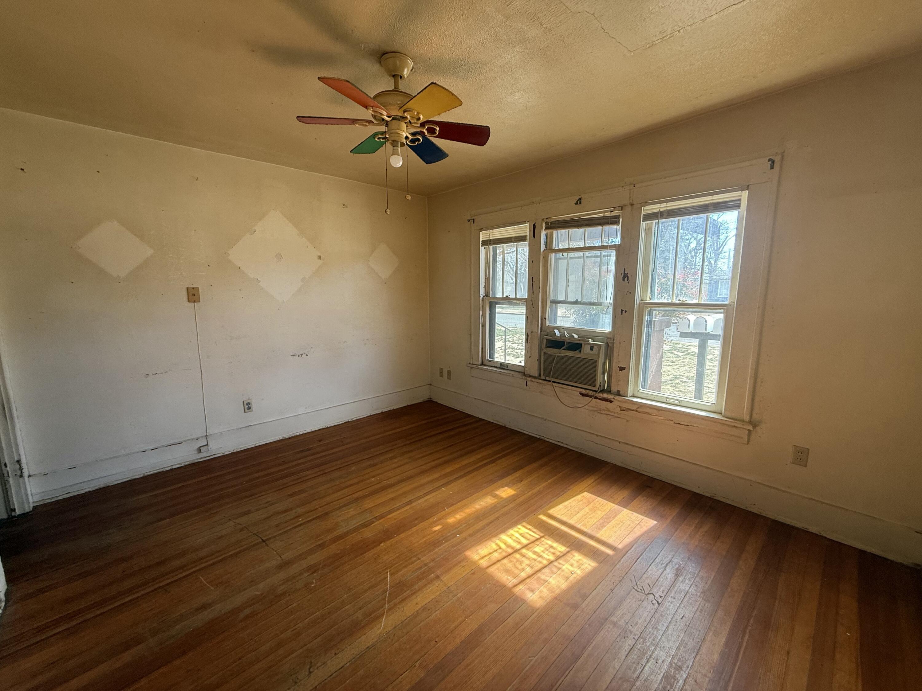 Package Package Property Lubbock, TX 79411 - Photo 64 of 71 a view of an empty room with wooden floor and a window