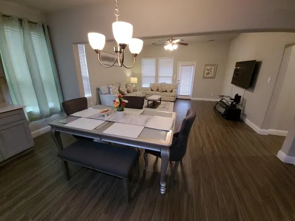 a view of a dining room with furniture and wooden floor