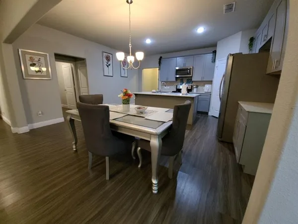 a view of a dining room with furniture and wooden floor