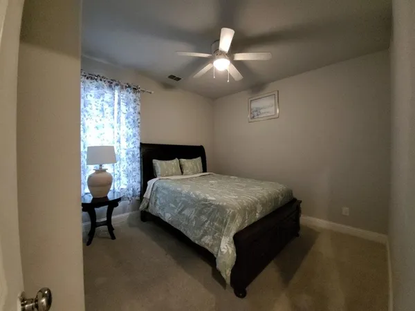 a bedroom with a bed and window
