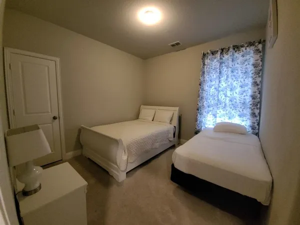 a bedroom with two beds and painted walls