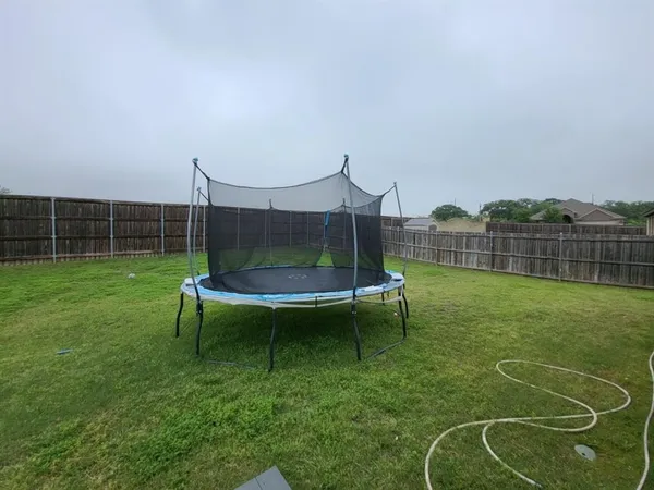 a view of a bench in the backyard
