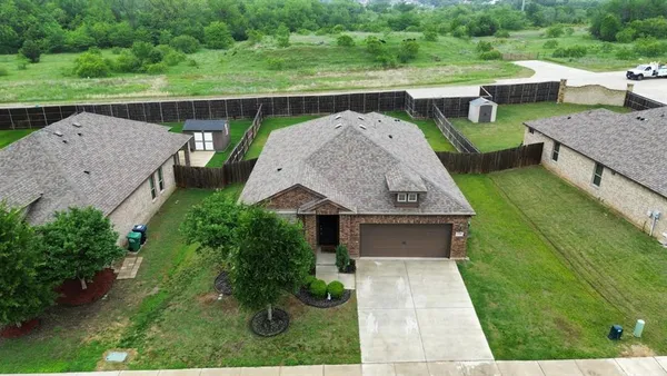 an aerial view of a house with a garden and plants