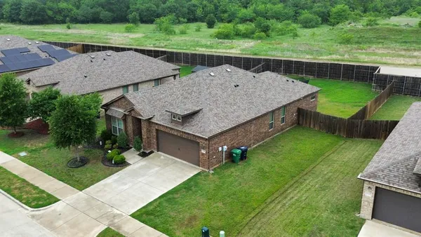 an aerial view of a house having yard and a patio