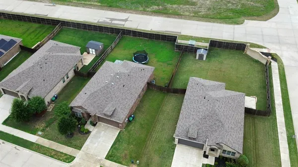 an aerial view of a house with a yard