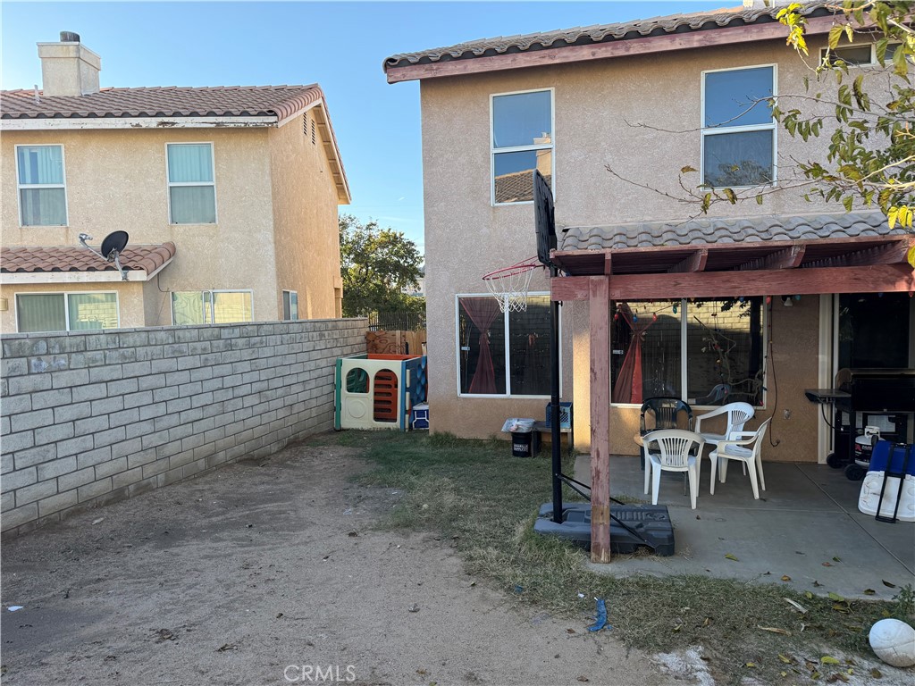 14565 Green River Road Victorville, CA 92394 - Photo 18 of 20 a view of a house with a patio and a yard