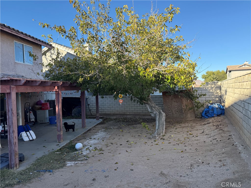 14565 Green River Road Victorville, CA 92394 - Photo 20 of 20 a backyard of a house with barbeque oven table and chairs