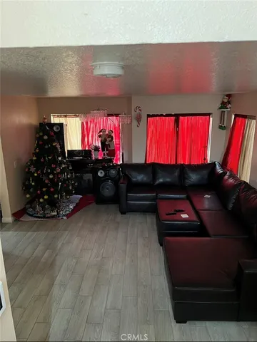 a room with red wall paintings and a flat screen tv