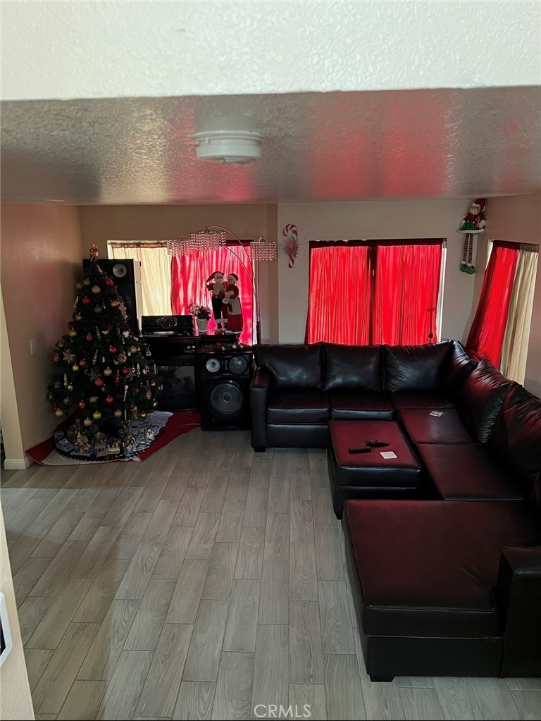 14565 Green River Road Victorville, CA 92394 - Photo 4 of 20 a room with red wall paintings and a flat screen tv