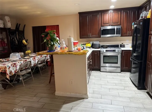 a kitchen with a sink appliances and cabinets