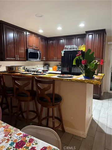 a kitchen with stainless steel appliances kitchen island granite countertop a sink and cabinets