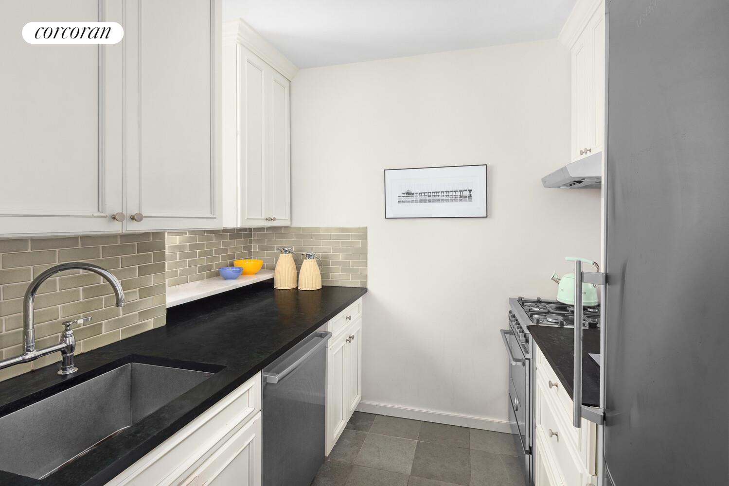 45 West 11th Street, Unit 4C Manhattan, NY 10011 - Photo 2 of 8 a close view of a sink a counter and cabinets in the kitchen