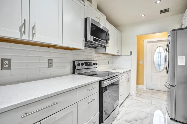a view of a dining room with furniture and a chandelier