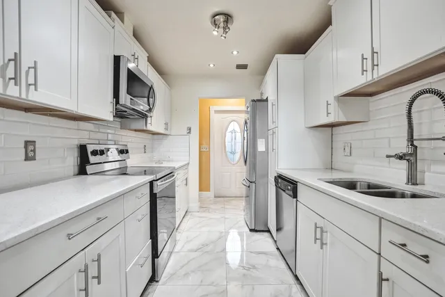 a view of a dining room with furniture and chandelier