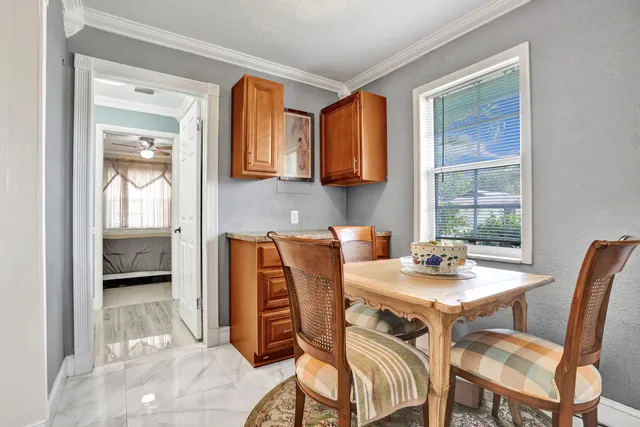 a living room with furniture dining table and a large window
