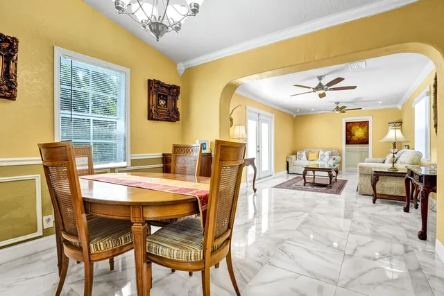 a living room with furniture and painting on the wall