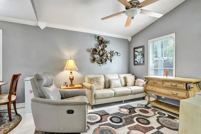 a bathroom with a granite countertop sink mirror vanity and toilet