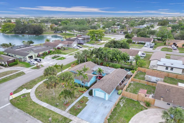 an aerial view of a house with a garden and trees