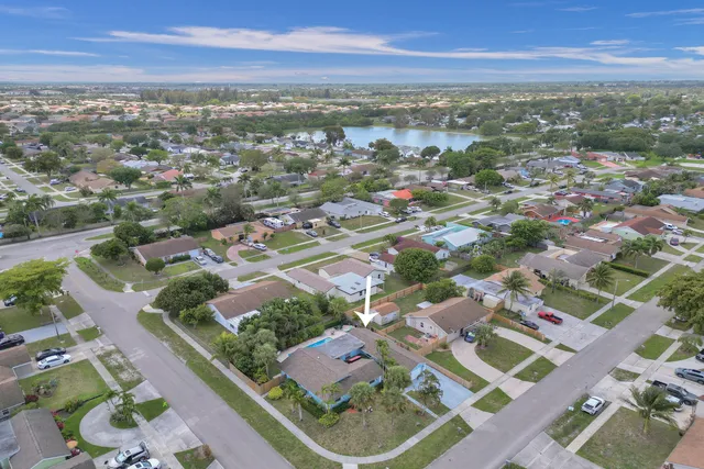 a view of a backyard with furniture and a fire pit