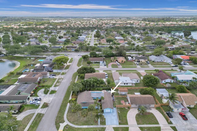 a bedroom with a bed ceiling fan and a window