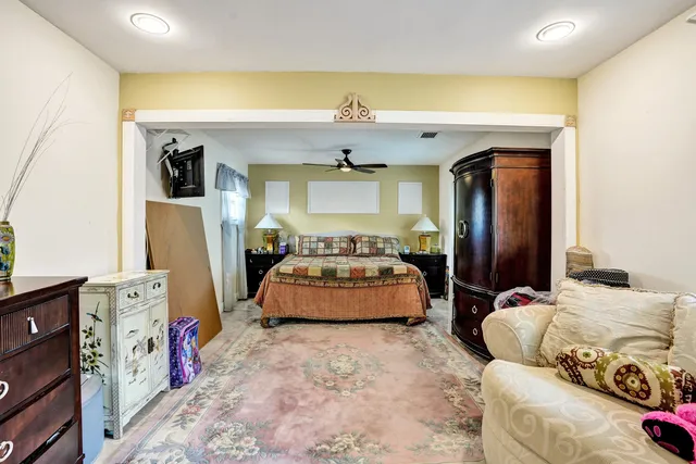 a bedroom with a bed and a chandelier