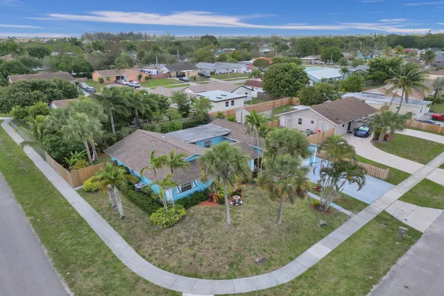 a kitchen with stainless steel appliances granite countertop a sink a refrigerator and cabinets
