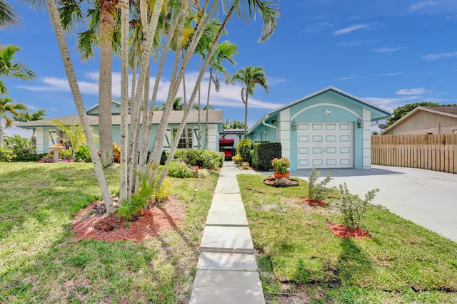 a large kitchen with stainless steel appliances kitchen island granite countertop a sink and cabinets