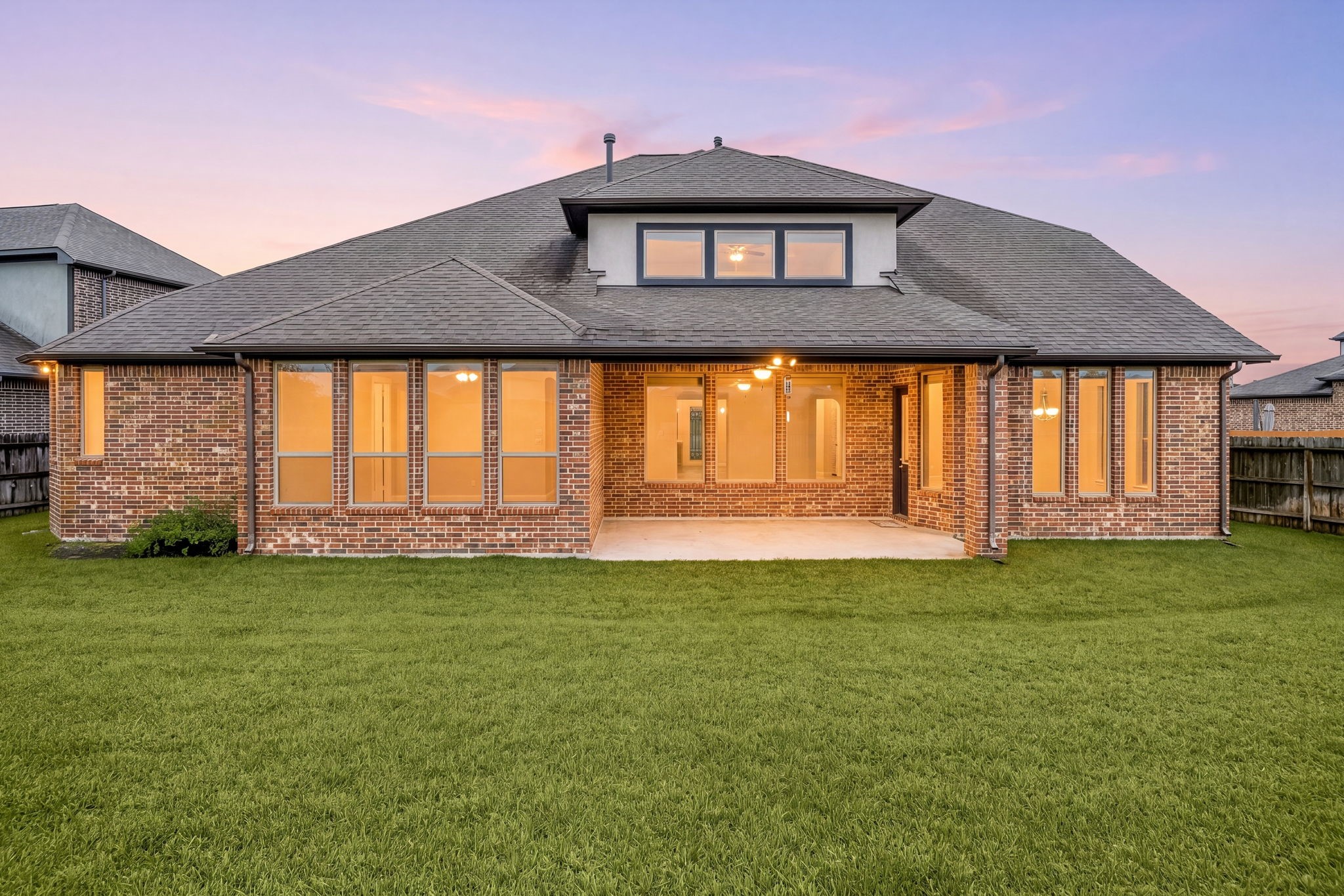 3622 Sage Hollow Drive Spring, TX 77386 - Photo 33 of 46 The rear elevation showcases the home's gorgeous full-brick construction and a spectacular wall of windows that seamlessly bridges the indoor living spaces with the beautiful outdoor setting.