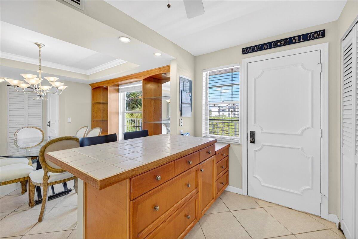 1 Harbourside Drive, Unit 3505 Delray Beach, FL 33483 - Photo 11 of 38 a kitchen that has a cabinets and a table in it