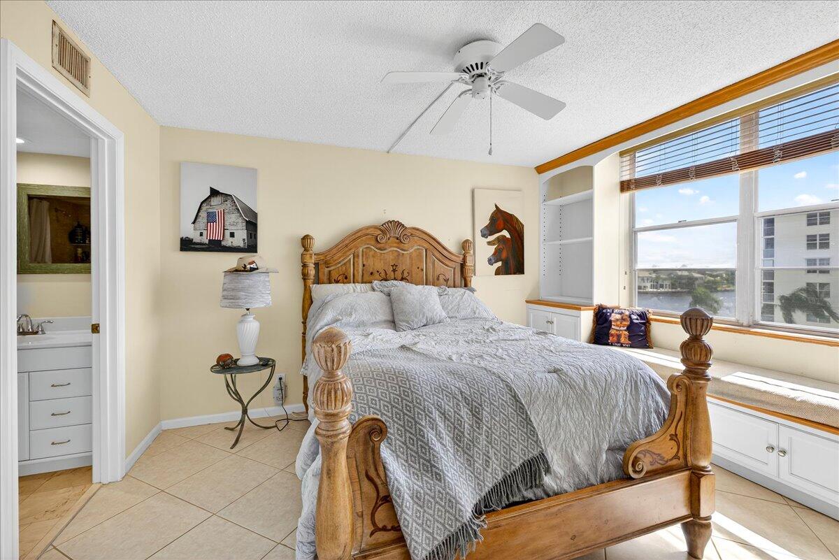 1 Harbourside Drive, Unit 3505 Delray Beach, FL 33483 - Photo 17 of 38 a bedroom with a bed and a chandelier