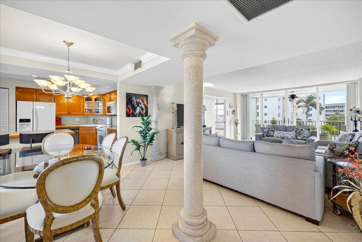 1 Harbourside Drive, Unit 3505 Delray Beach, FL 33483 - Photo 2 of 38 a living room with dining table and a chandelier