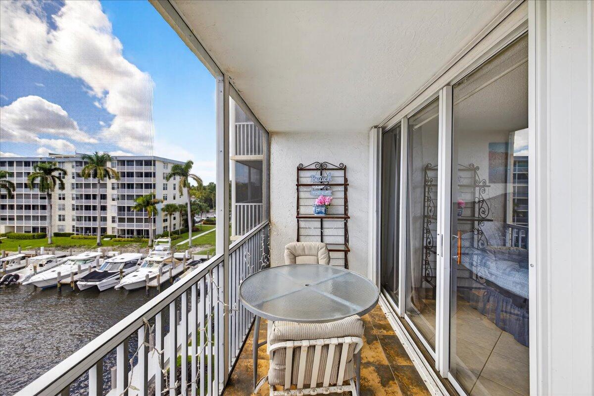 1 Harbourside Drive, Unit 3505 Delray Beach, FL 33483 - Photo 22 of 38 a balcony with a table and chairs