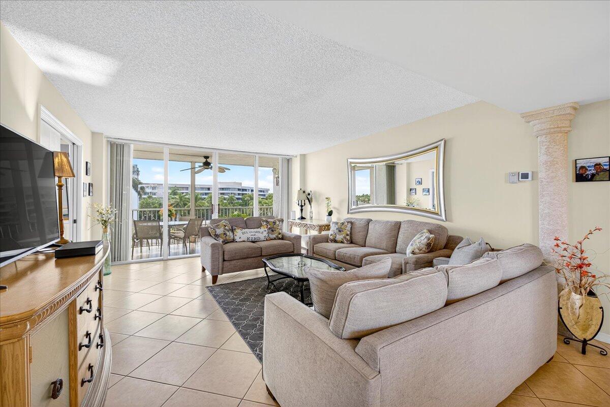 1 Harbourside Drive, Unit 3505 Delray Beach, FL 33483 - Photo 3 of 38 a living room with furniture a flat screen tv and a large window