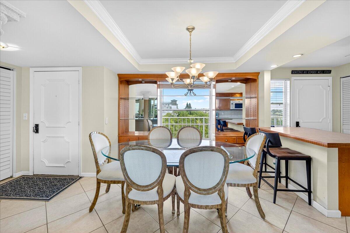 1 Harbourside Drive, Unit 3505 Delray Beach, FL 33483 - Photo 6 of 38 a dining room with furniture a chandelier and wooden floor