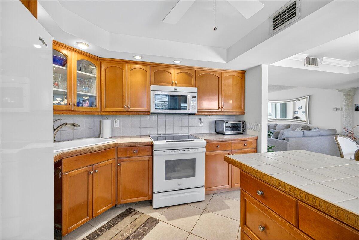 1 Harbourside Drive, Unit 3505 Delray Beach, FL 33483 - Photo 10 of 38 a kitchen with stainless steel appliances granite countertop a sink and cabinets