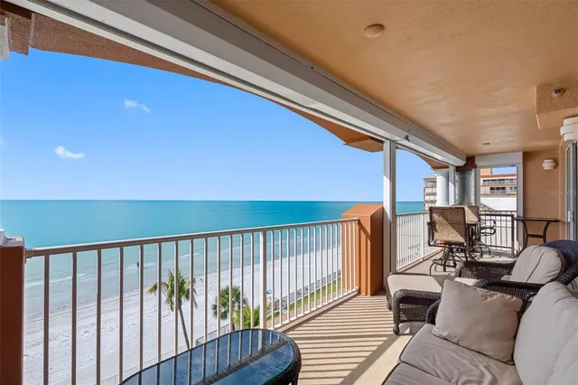 a balcony with table and chairs