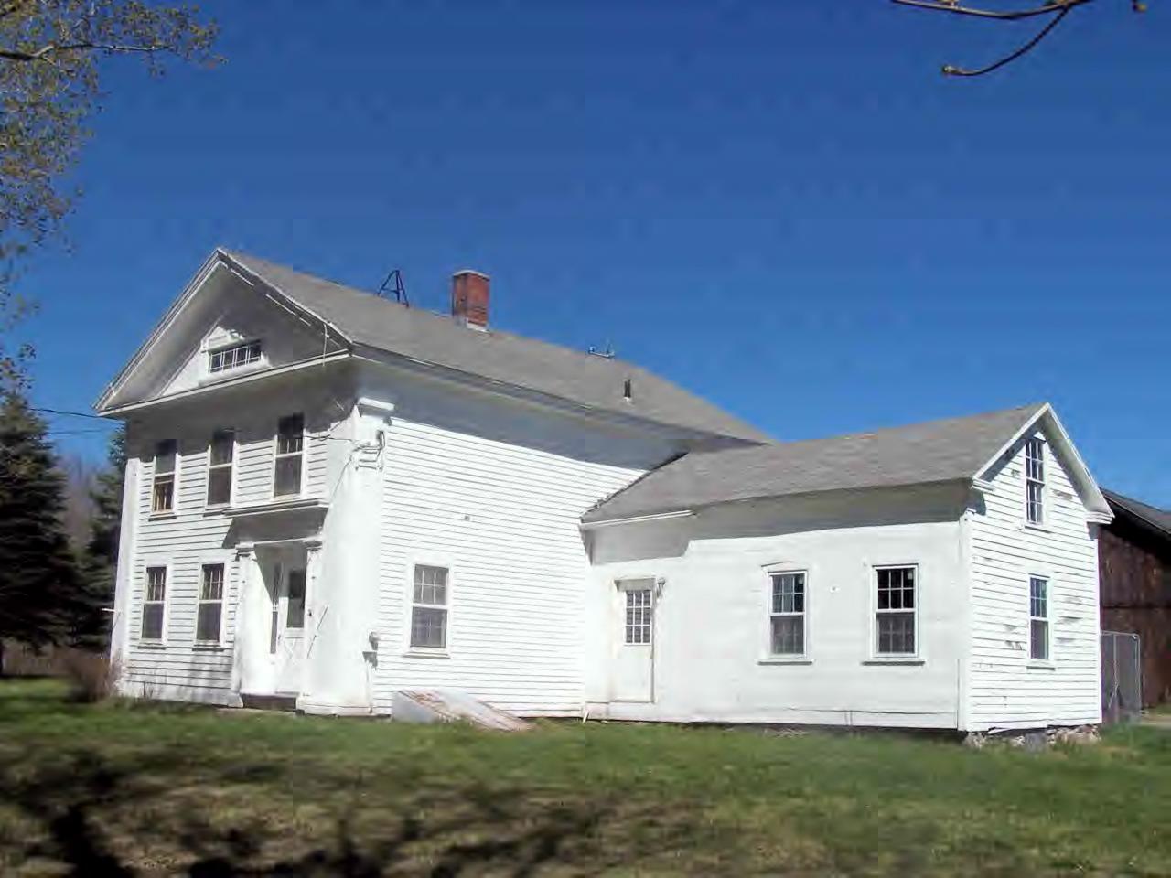 399 West Granville Road Tolland, MA 01034 - Photo 1 of 3 a view of a white house next to a yard with big trees
