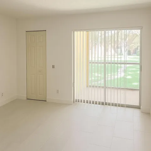 a view of an empty room with a window