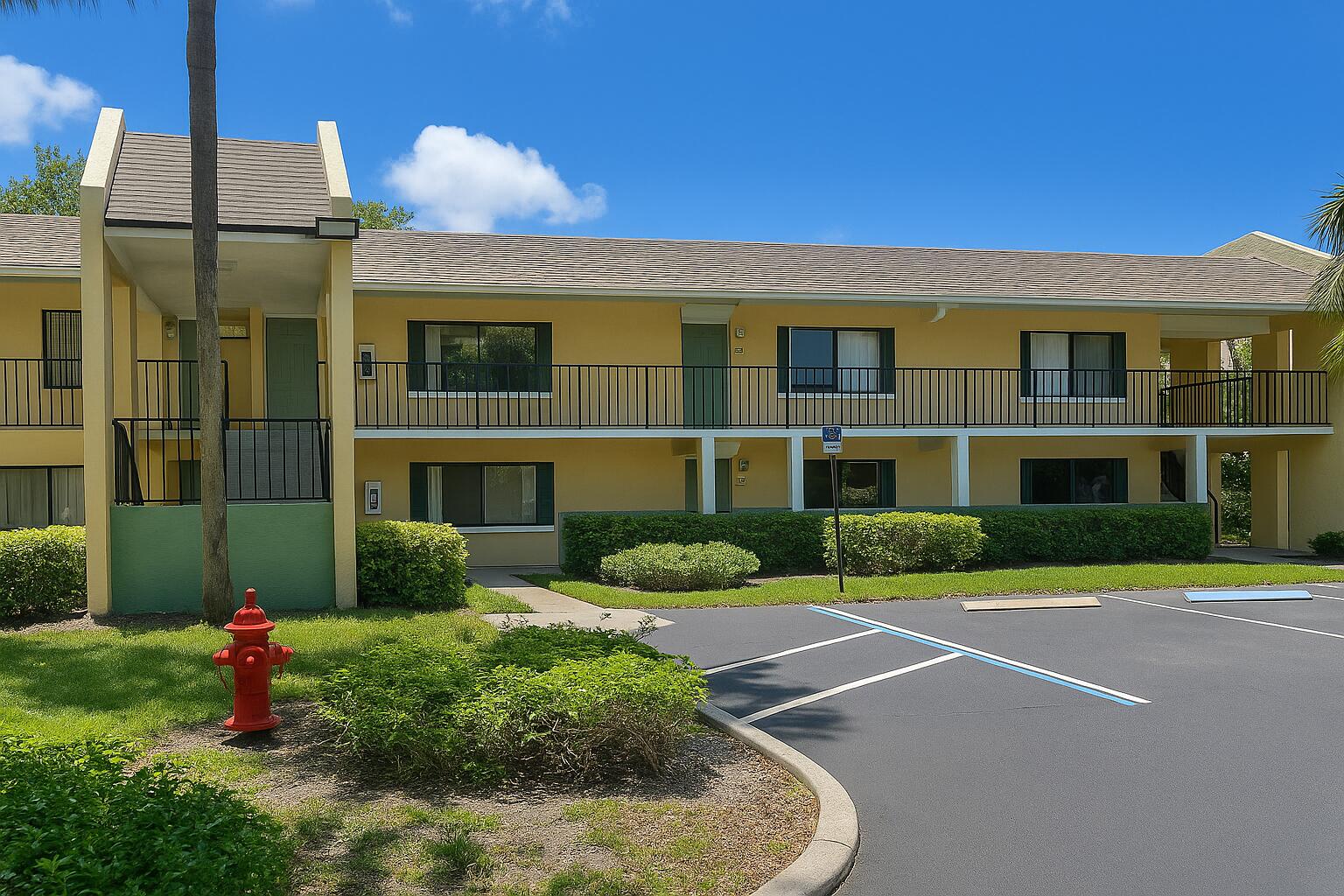 1011 Meadows Circle Boynton Beach, FL 33436 - Photo 4 of 8 a front view of a building with garden