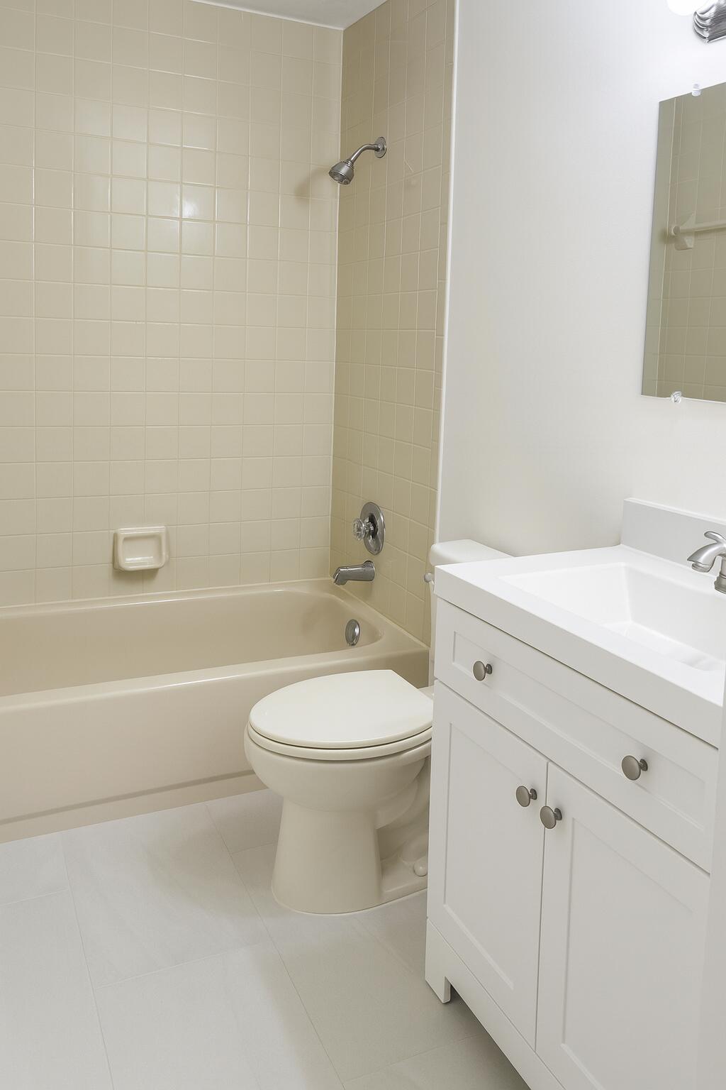 1011 Meadows Circle Boynton Beach, FL 33436 - Photo 5 of 8 a bathroom with a toilet a sink a mirror and vanity