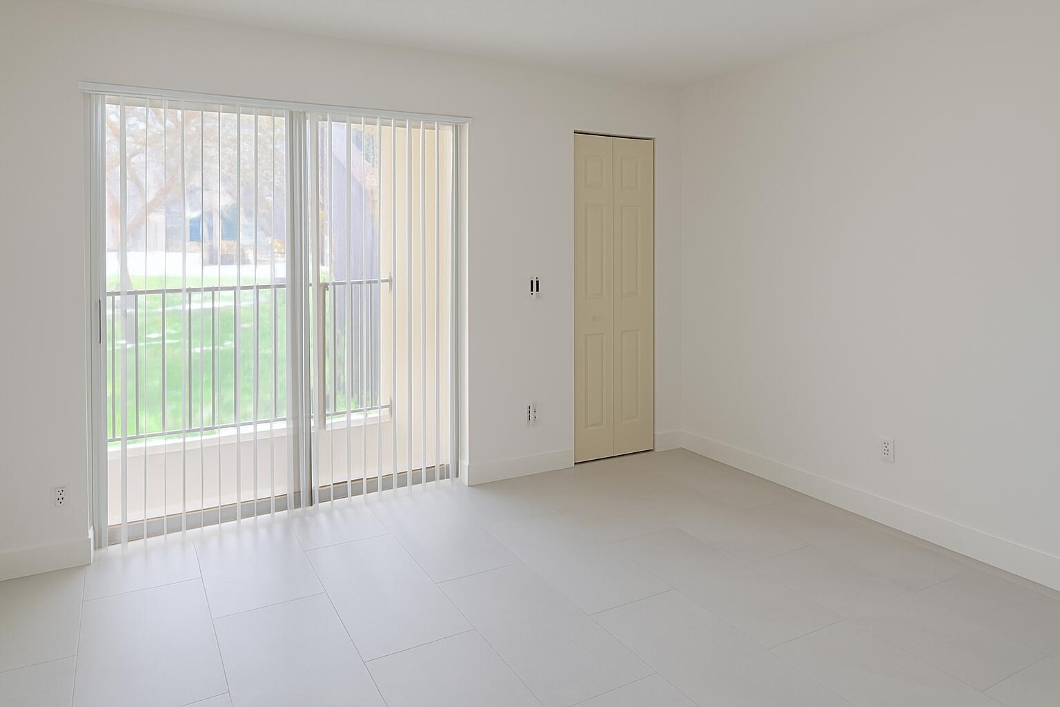 1011 Meadows Circle Boynton Beach, FL 33436 - Photo 6 of 8 a view of an empty room with wooden floor and a window
