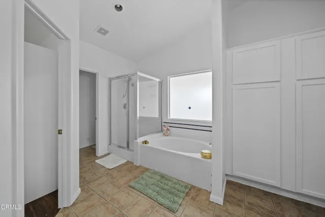 a bathroom with a tub and shower