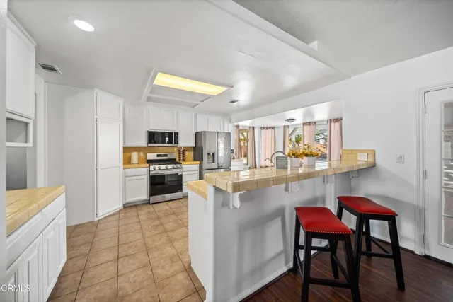 a kitchen with a sink a counter top space and appliances