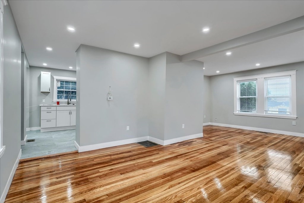 25 Patterson Street Boston, MA 02124 - Photo 11 of 32 a view of an empty room with wooden floor and a window