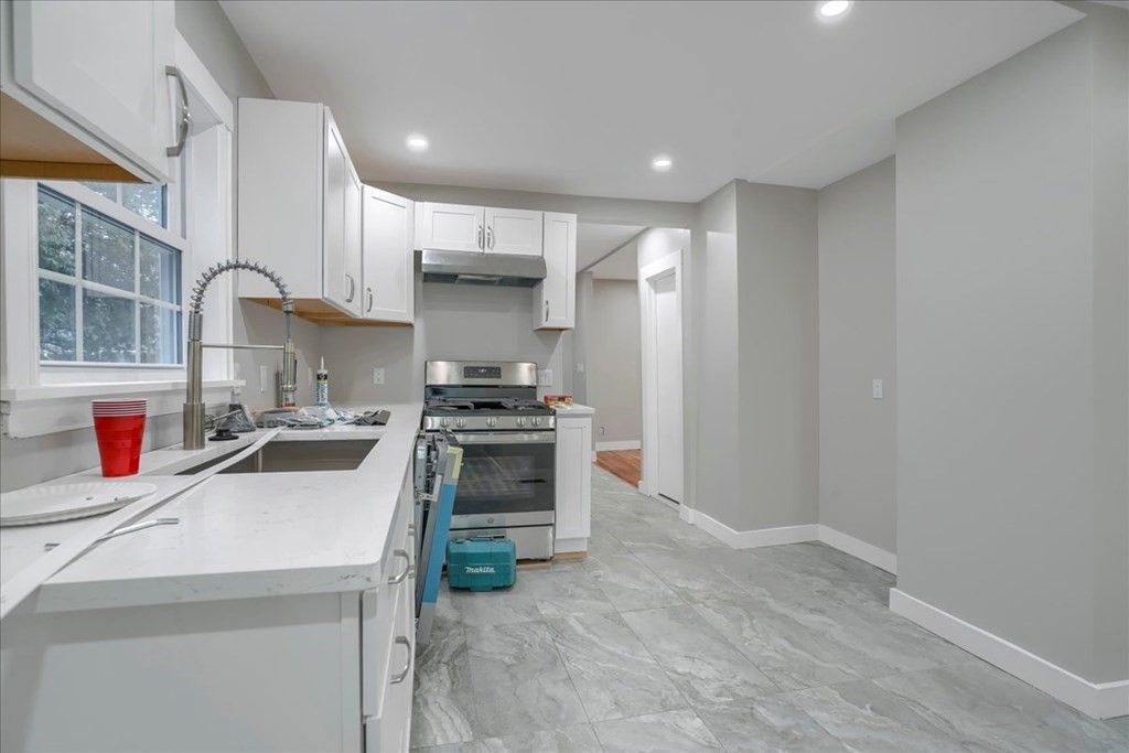 25 Patterson Street Boston, MA 02124 - Photo 14 of 32 a kitchen that has a sink and a stove in it