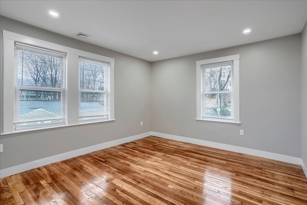 25 Patterson Street Boston, MA 02124 - Photo 20 of 32 a view of empty room with wooden floor and fan